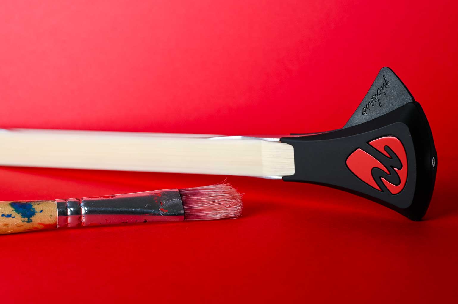 Pickaso Guitar Bow Red Color on red background with red paintbrush 